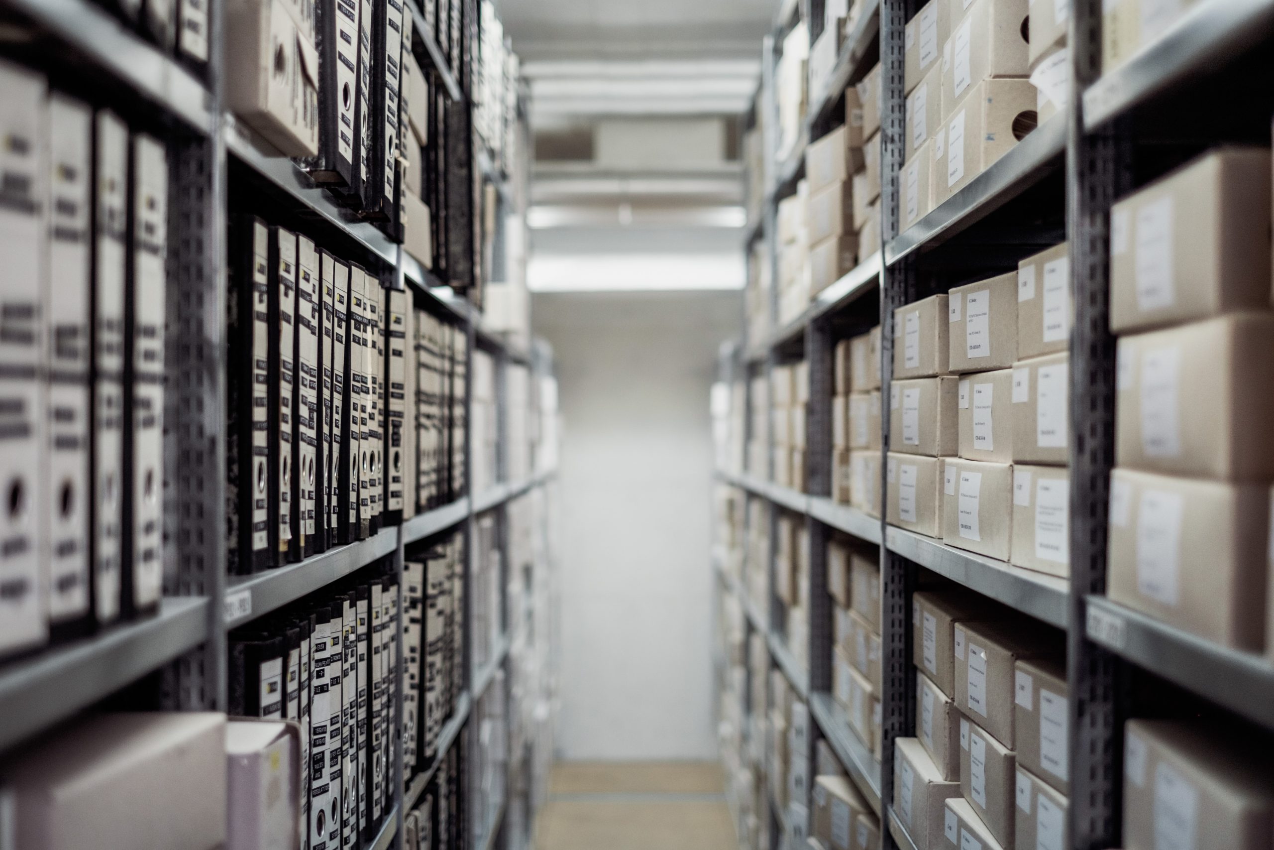 Moving boxes stacked on shelves